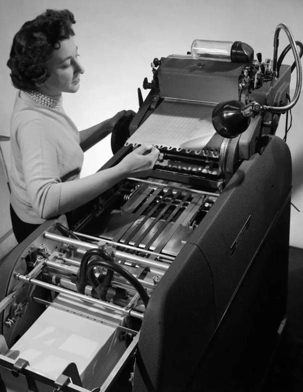 Woman operating a Multilith duplicating machine, circa 1955